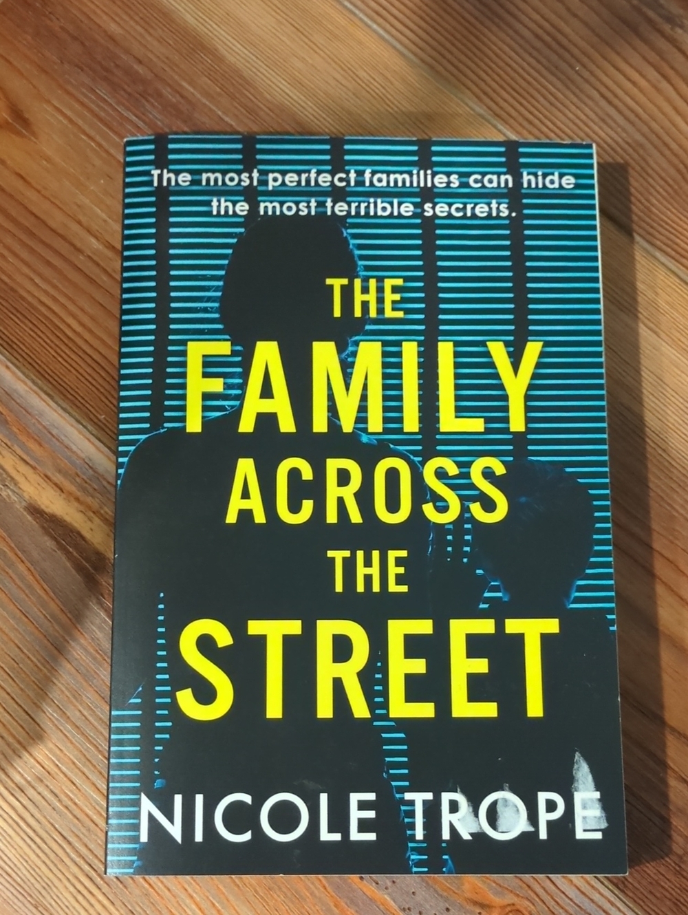 The Family Across The Street by Nicole Trope - Yellow & Teal Cover